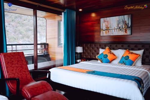 a bedroom with a bed and a red chair at Blue Diamond Cruise in Ha Long