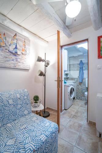 a living room with a bed and a washing machine at Holiday House Nova in Stara Baška