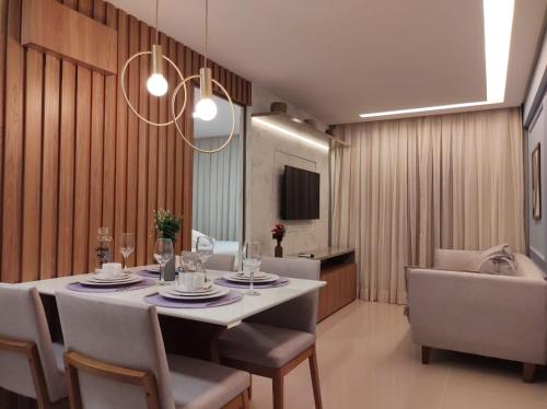 a dining room with a white table and chairs at Rio Park Ave, Sea View One - By TRH Invest in Recife