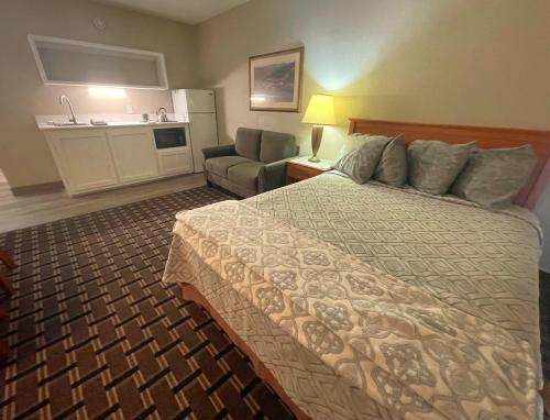 a hotel room with a bed and a couch at FairBridge Extended Stay, a Kitchenette Hotel in Idaho Falls