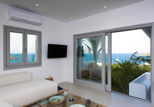 a living room with a view of the ocean at Mykonos Serendipity Villas in Platis Yialos Mykonos