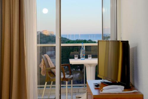 a television sitting on a table in front of a window at Residence Residéal Antibes in Antibes