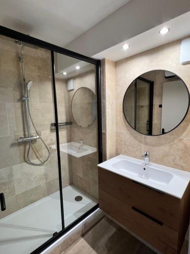 une salle de bain avec un lavabo, une douche et un miroir dans l'établissement En front de Mer, Magnifique Appartement 6 pers., au Cap d'Agde