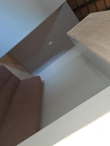 a close up of a white table with a wooden top at Horizon View Chalets in Graskop