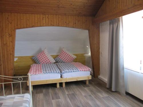 a bedroom with a bed with pink pillows on it at Apartment Natali in Schnaittenbach