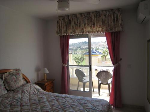 a bedroom with a bed and a window with a view at Casa Yvonne in Rojales