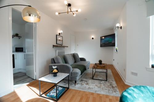 a living room with a couch and a table at St George's Residence in Glasgow