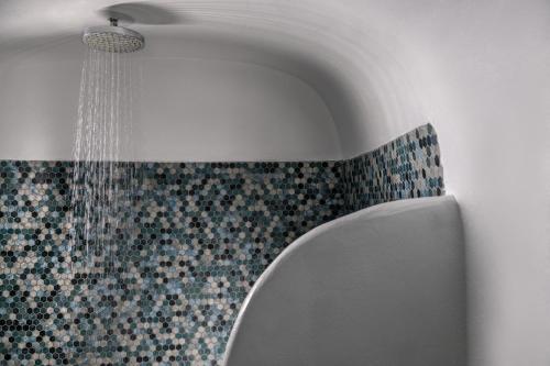 a shower in a bathroom with a shower at Caldera Premium Villas in Oia