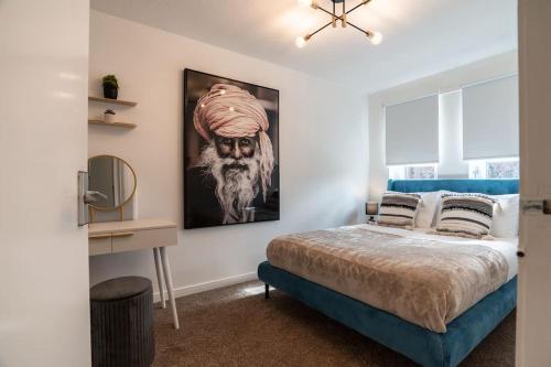 a bedroom with a bed with a painting on the wall at St George's Residence in Glasgow