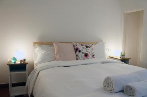 a bedroom with a large white bed with pillows at Friends of Michelangelo in Florence