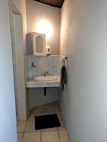 a bathroom with a sink and a mirror at Horizon View Chalets in Graskop