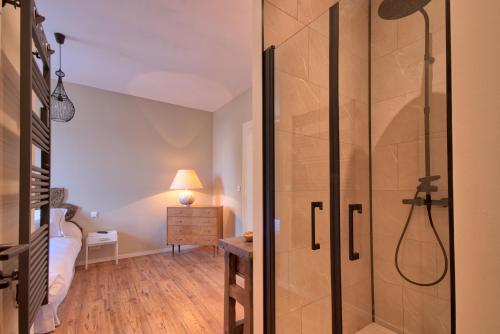 a bathroom with a shower and a bedroom at Appartement Complet Rez-de-chaussée in Sains-Richaumont