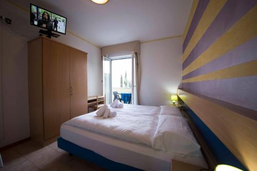 Postel nebo postele na pokoji v ubytování Hotel Vela Azzurra