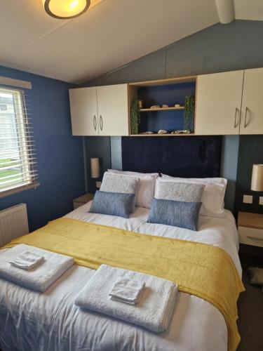a bedroom with two beds with towels on them at The Oyster Shell in Whitstable