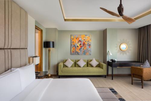 a hotel room with a bed and a couch at Radisson Blu Resort Galle in Galle