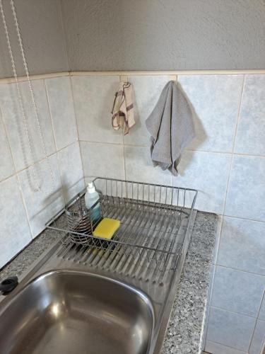 a sink with a metal rack on top of it at Horizon View Chalets in Graskop