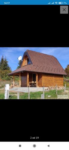 a large wooden house with a brown roof at brvnare in in Sekulić 