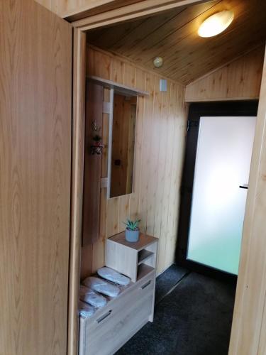 a small room in a tiny house with a mirror at Cozy attic studio in Braşov