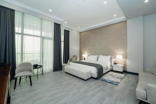 a bedroom with a bed and a living room at Hills Resort Hotel in Yerevan