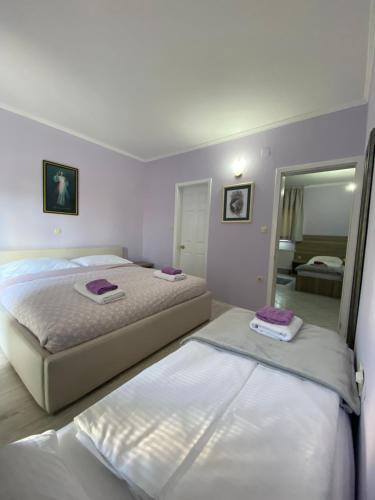 a bedroom with two beds and a mirror at St Michael in Međugorje