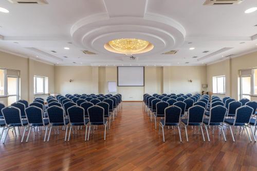 a large room with chairs and a projection screen at Sonata Hotel & Restaurant "готель Соната" in Lviv
