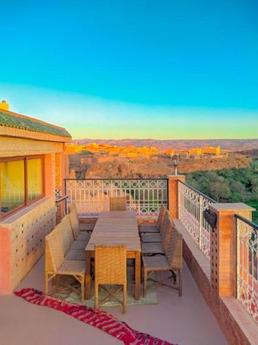 a table and chairs on a balcony with a view at Kasbah Assafar in Kalaat MGouna