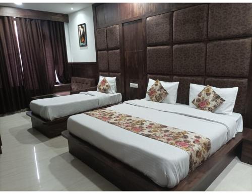 a hotel room with two beds in a room at Hotel Virat International AVR Shopping, Katra in Katra