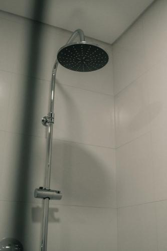 a shower with a shower head in a bathroom at Apartamento Mar & Bor - RRAL nº3126 in Praia da Vitória