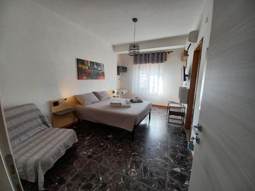 a living room with a bed and a couch at B&B Cardedu in Cardedu