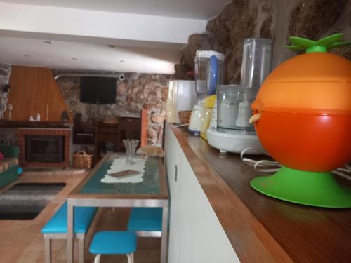 a kitchen with an orange bowl on a counter at Caramulo - Abrigo Serrano in Carvalhal da Mulher