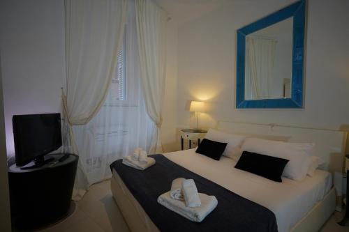 ローマにあるAureliana Apartmentsのベッドルーム1室(ベッド1台、タオル2枚付)