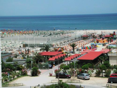 a beach with a lot of umbrellas and the ocean at Villetta Botticelli in Lido di Spina