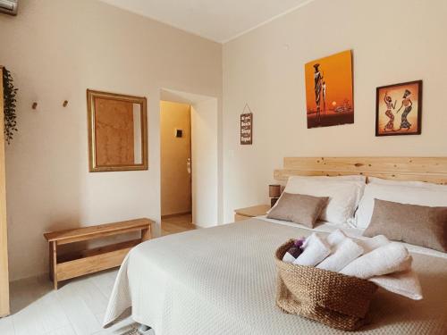 a bedroom with a white bed with towels on it at Villa Corocael in Castellabate