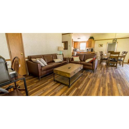 a living room with two couches and a table at Shady Shores RV Resort & Campground 