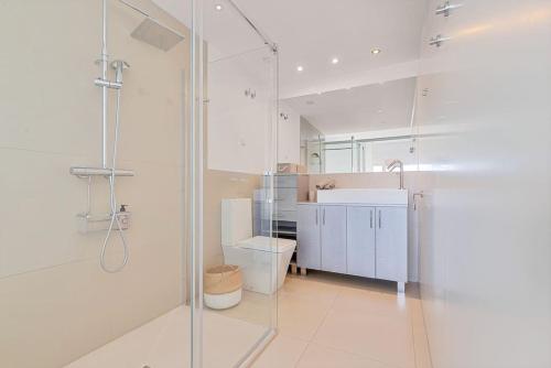 łazienka z przeszkloną kabiną prysznicową i umywalką w obiekcie Stylish apartment with oceanview w Maladze