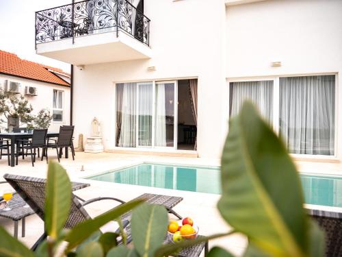 a villa with a swimming pool and a patio at Elegant Hvar town villa with pool in Hvar