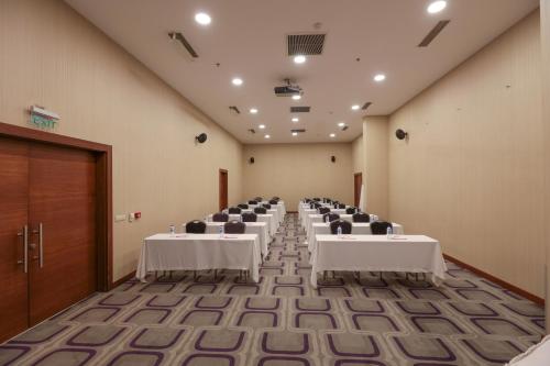 a room with rows of tables and chairs in it at Niza Park Hotel in Ankara