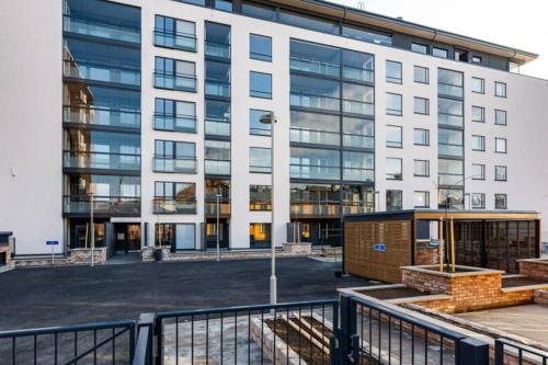 a large white building with a lot of windows at Modern 1 bedroom apartment with a patio in Turku