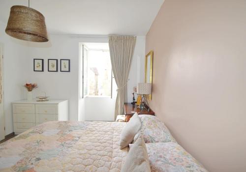 a bedroom with a bed and a window at Joli Canard in Badefols-dʼAns