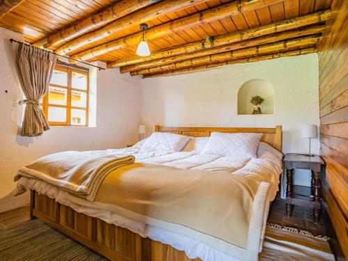 Postel nebo postele na pokoji v ubytování Hacienda Maimará