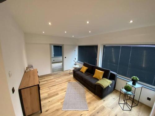 a living room with a couch and a large window at Wunderschöne 2,5 - Zimmer- Ferienwohnung mit Terrasse und Fernblick im Vordertaunus in Schmitten