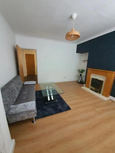 a living room with a couch and a fireplace at 1-Bedroom A Greater Manchester in Middleton