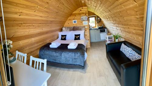 1 dormitorio con 1 cama y 1 sofá en una habitación en Earls View Maxi Pod, en Carna