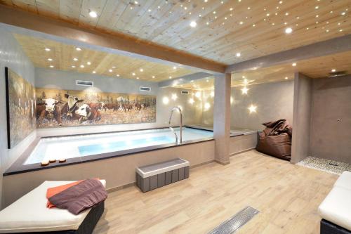 a room with a swimming pool and a couch at La Clef des Champs in Morzine