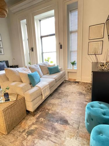 a living room with a white couch and blue pillows at New Haven Stays in New Haven