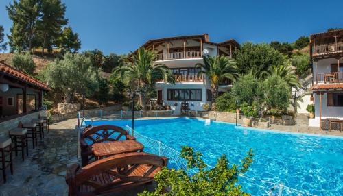 a villa with a swimming pool in a resort at Porto Koufo Resort in Porto Koufo