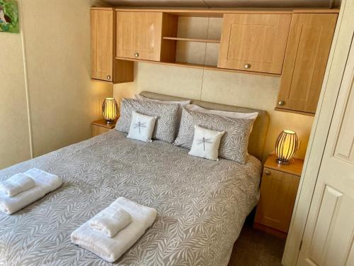 a bedroom with a bed with two pillows on it at Earls View Caravan in Carna