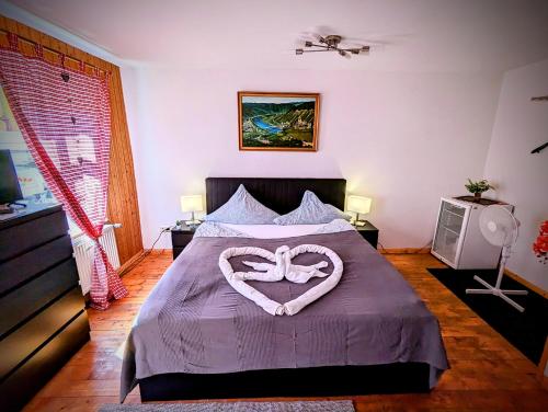 a bedroom with a bed with a heart decoration on it at Gästehaus Pension Romantika in Cochem
