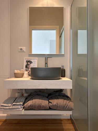 a bathroom with a sink and a mirror at B&B SU SICCU in Cagliari