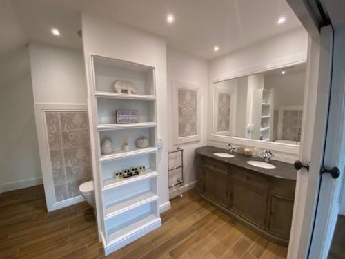 a bathroom with two sinks and a toilet at Luxury Five Star, Hampton House With Heated Pool in Bembridge